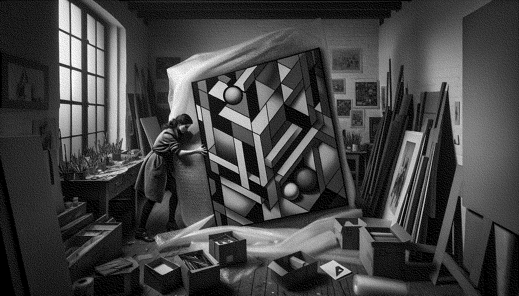 Artist in the studio trying to get bubble wrap around a painting and struggling